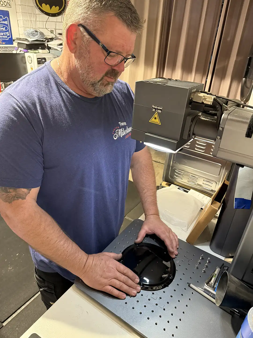 Phil Taylor preparing a motorcycle component at his engraving machine